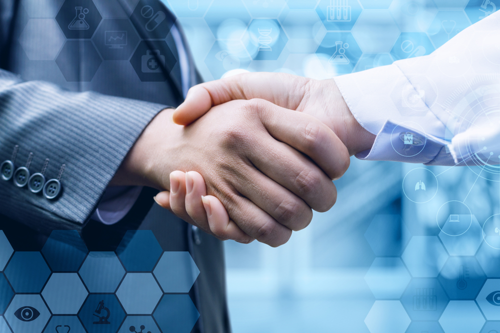 Handshake,Of,A,Businessman,And,A,Doctor,On,Blurred,Background.