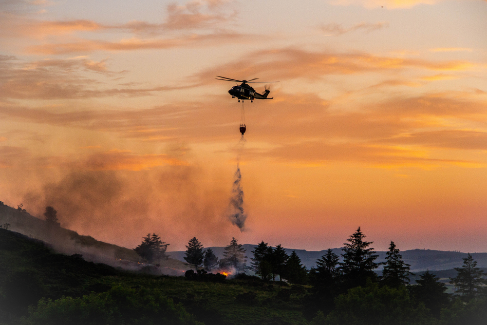 Helicopter,Dropping,Water,From,Water,Bucket,In,Night,Sky