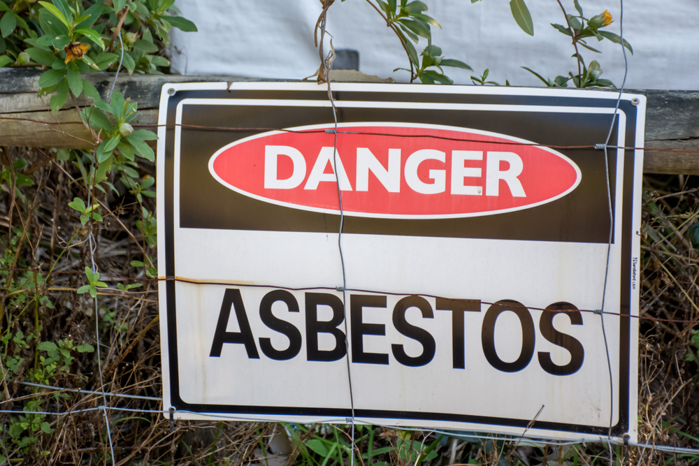 A,Warning,Sign,Danger,Asbestos,On,A,Fence,At,Site