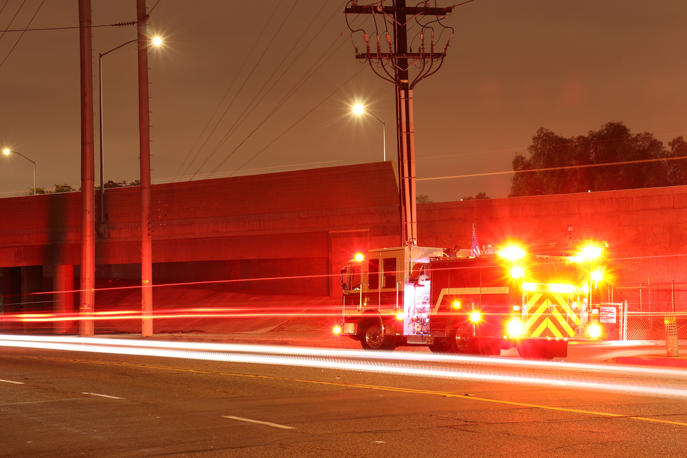 Fire,Truck,With,Lights,On,At,Night