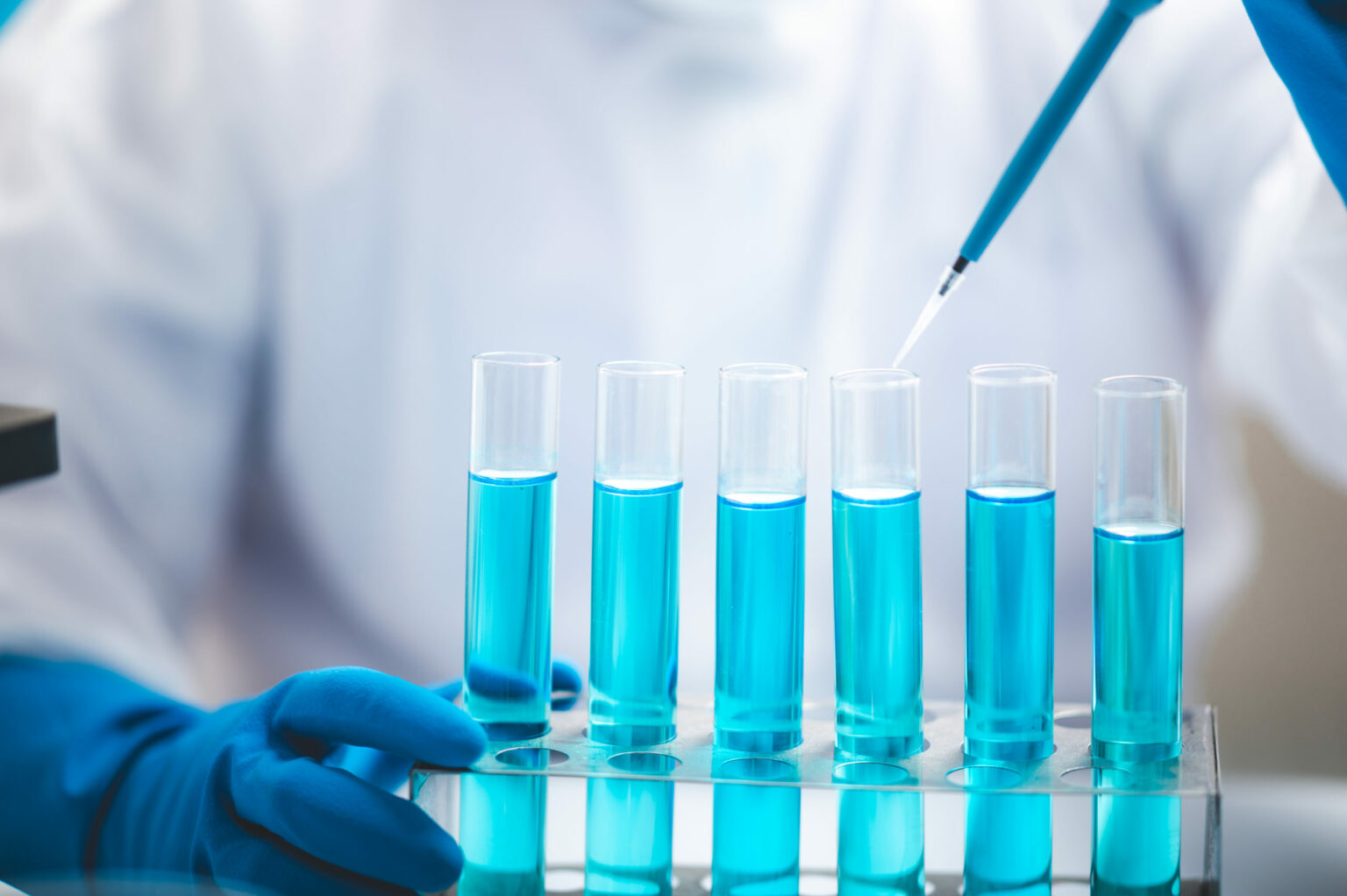 Researchers,Scientist,Working,Analysis,With,Blue,Liquid,Test,Tube,In
