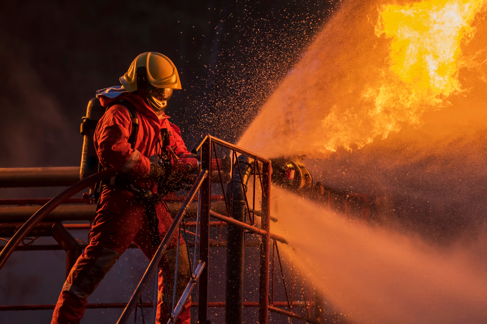 Firefighter,In,The,Training,With,Fire,Hose,Nozzle,Spraying,High