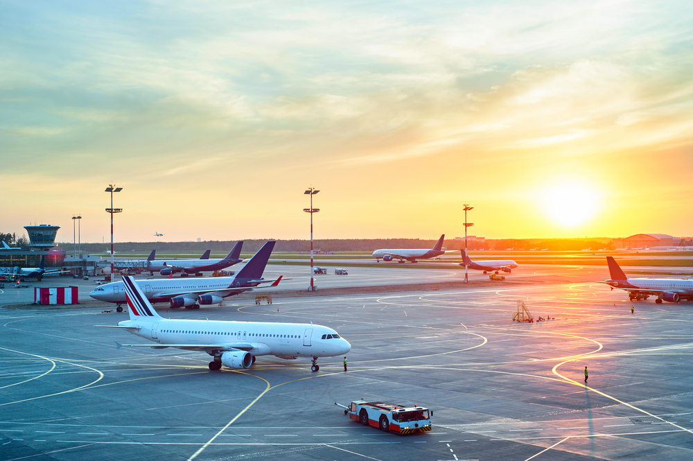 Airport,With,Many,Airplanes,At,Beautiful,Sunset