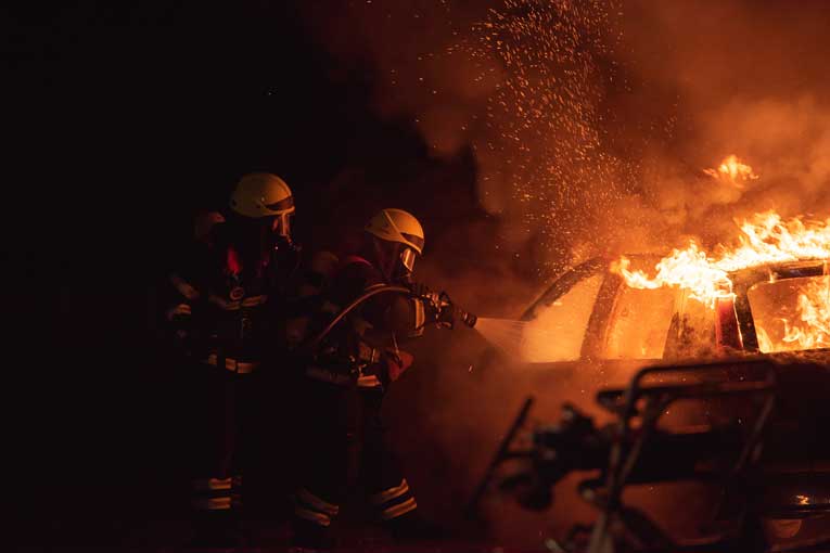 Firefighters Controlling Car Fire