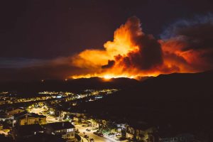 California wildfire burns near a residential area at night