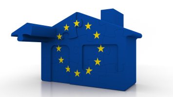 Building puzzle house featuring flag of the European Union. EU emigration or construction conceptual 3D rendering