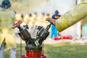 Blurred,Photo,Firemen,Using,Water,From,Hose,For,Fire,Fighting
