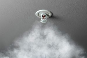 Fire,Alarm,Sprinkler,System,In,Action,With,Smoke