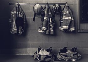 Firefighter,Gear,With,Fire,Hoses,And,Truck